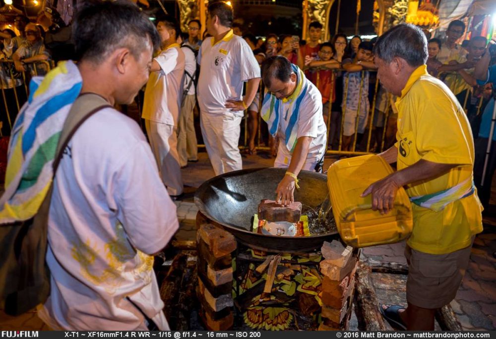 Pouring the oil into the wok to heat it once they start the fire under it.