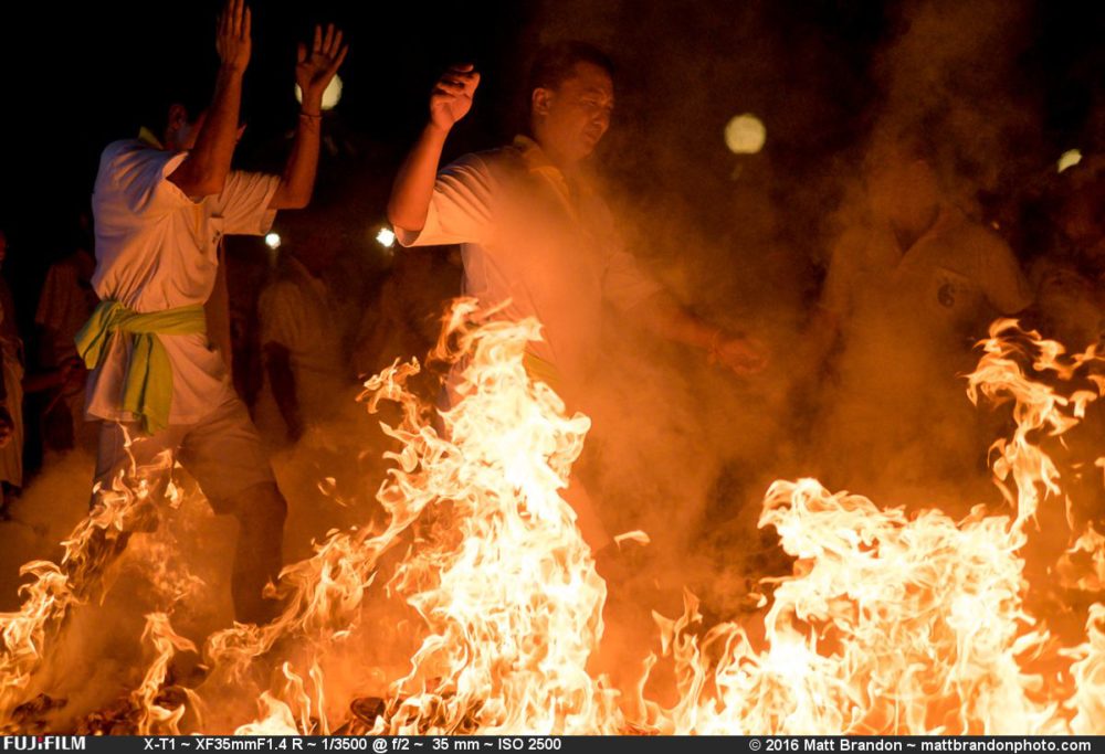 As if walking through hell, these devotees walk over burning coals and paper.