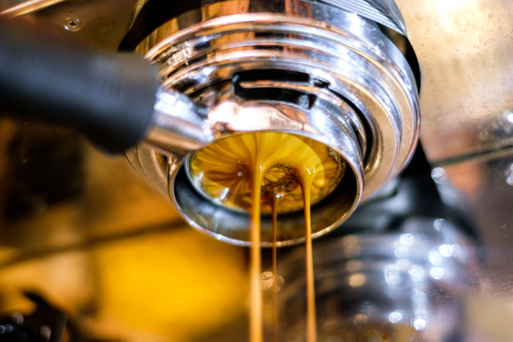 Coffee and it's lovely crema being extracted through a bottomless or naked portafilter. 
