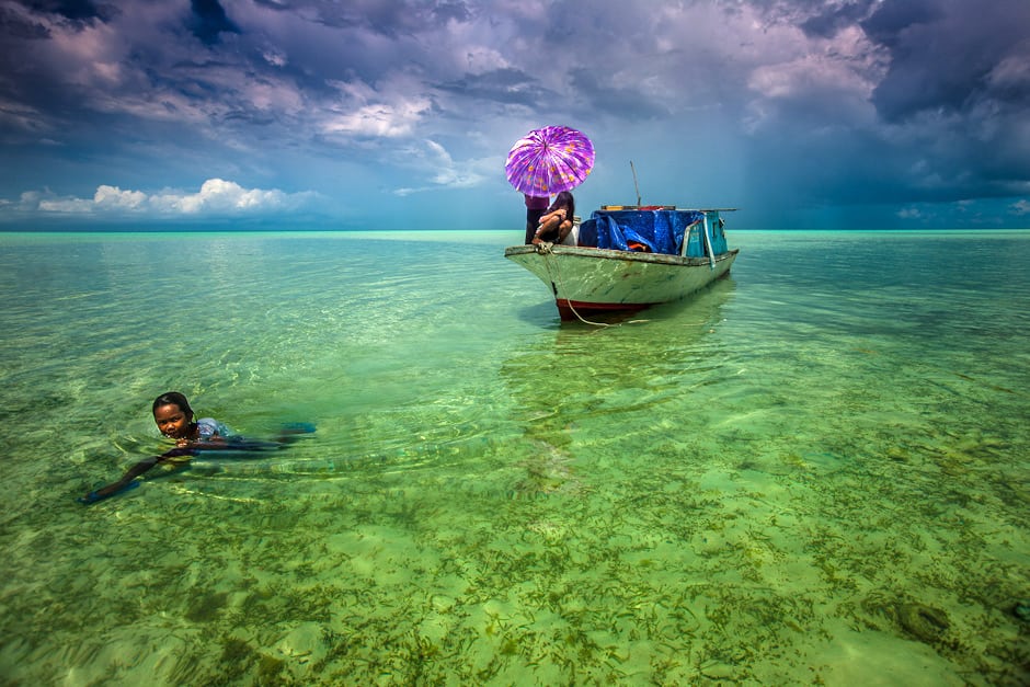 The Bajau look down at the fish.